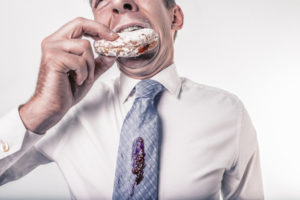 man spills jelly donut on tie