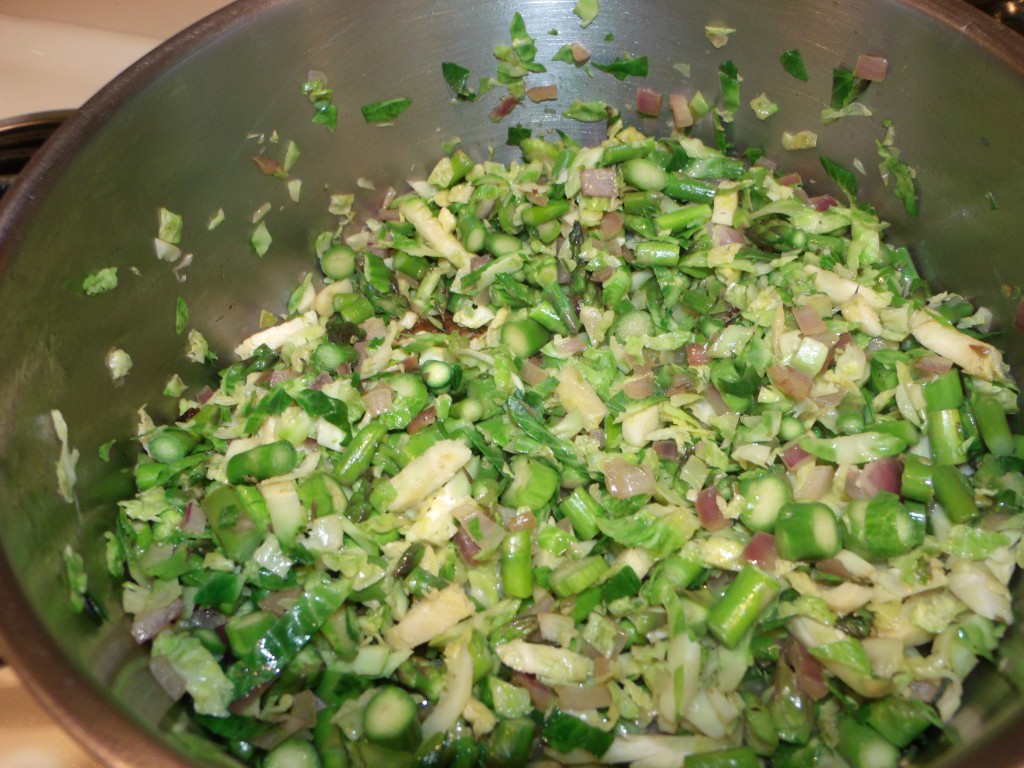 Add the chopped Brussels sprouts Asparagus, Brussels sprouts, Onions, Almonds, Turkey Bacon, Craisins, Goat Cheese