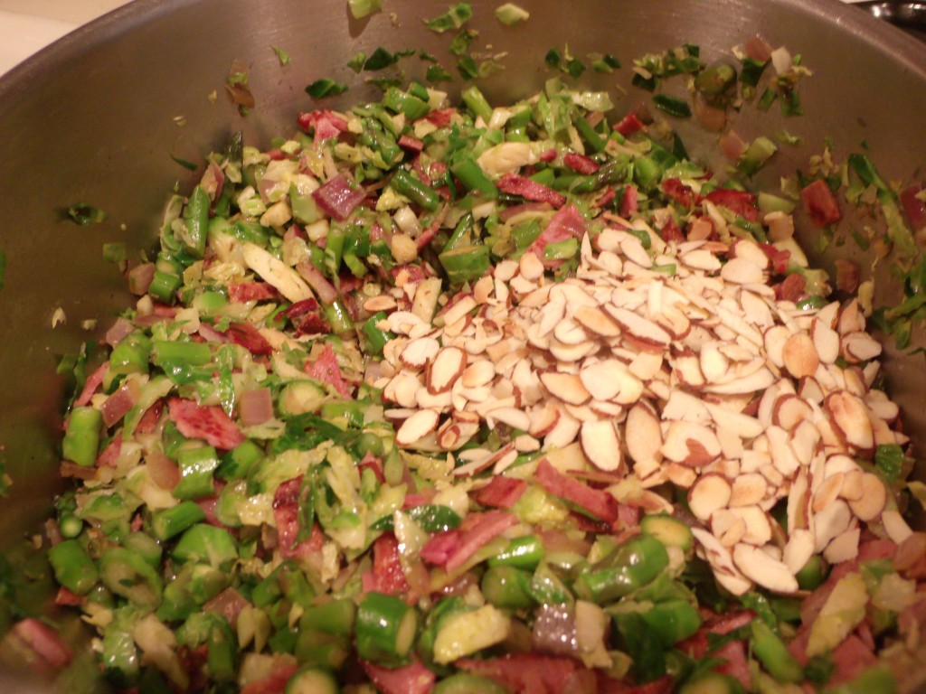 Add the almonds Asparagus, Brussels sprouts, Onions, Almonds, Turkey Bacon, Craisins, Goat Cheese