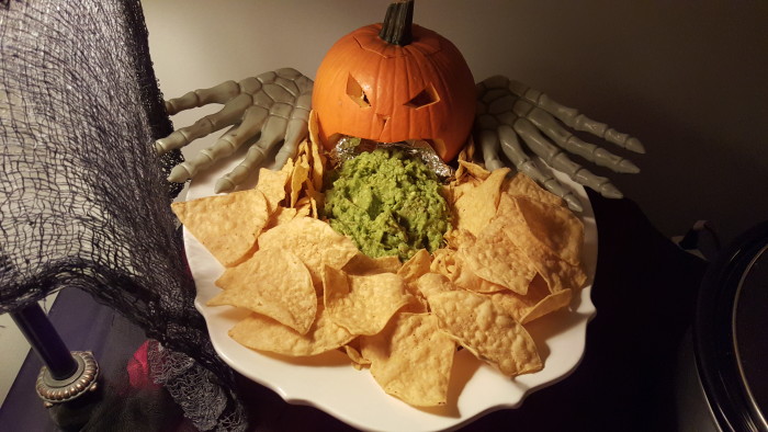 This puking pumpkin is always the hit of the party. I made homemade guac, carved a pie pumpkin, and surrounded it with chips