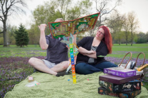 engagement photo shoot with the game of life throwing the game in the air