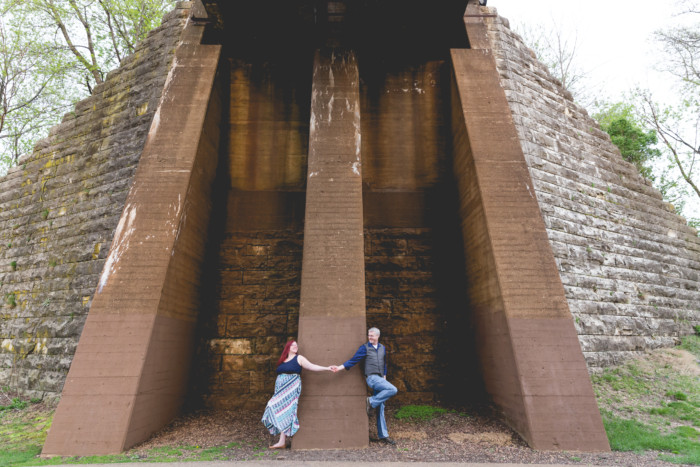 engagement photo session under a train bridge around the corner from each other