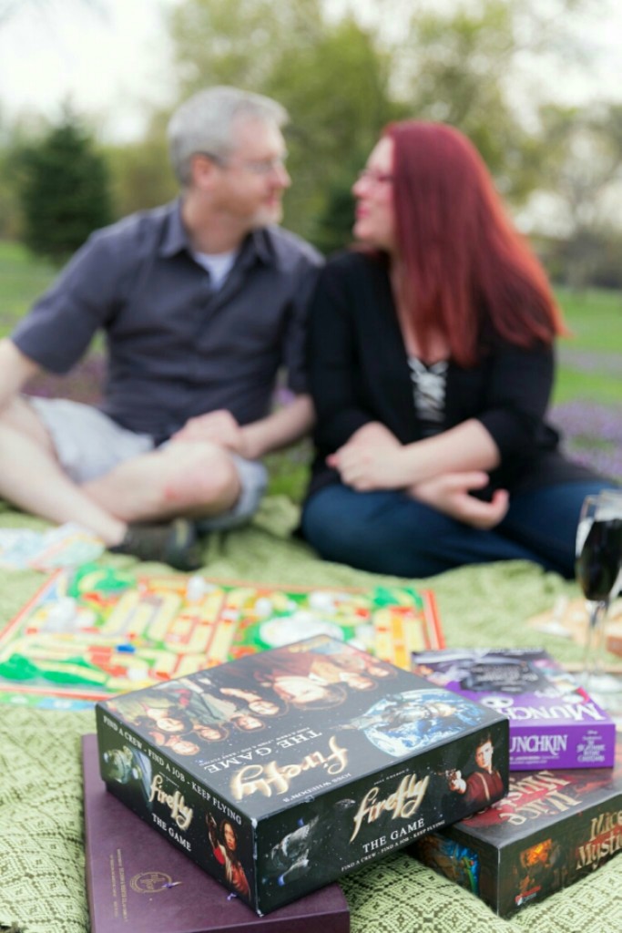 adorable engagement photo with board games and a picnic