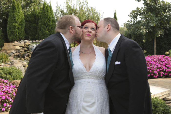 My bridesmen kissing me on the cheek at the wedding