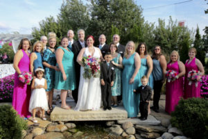 the full bridal party with bride, groom, groomsman, bridesmaids, ushers/bridesmen, something blue crew, flower girl, and ring bearer.