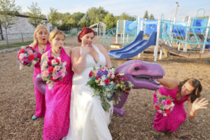 we took wedding photos at a playground, and had so much fun on the purple dinosaur.