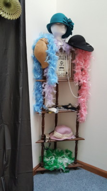 Photo booth station with costume add-ons for a 20s themed bachelorette party 