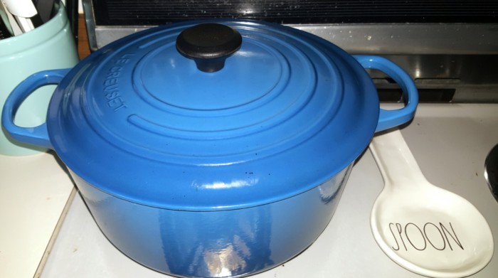 Blue Le Creuset sitting on stovetop