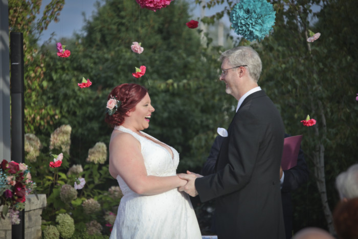 bride laughing during wedding ceremony