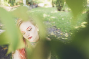 Girl hiding behind tress