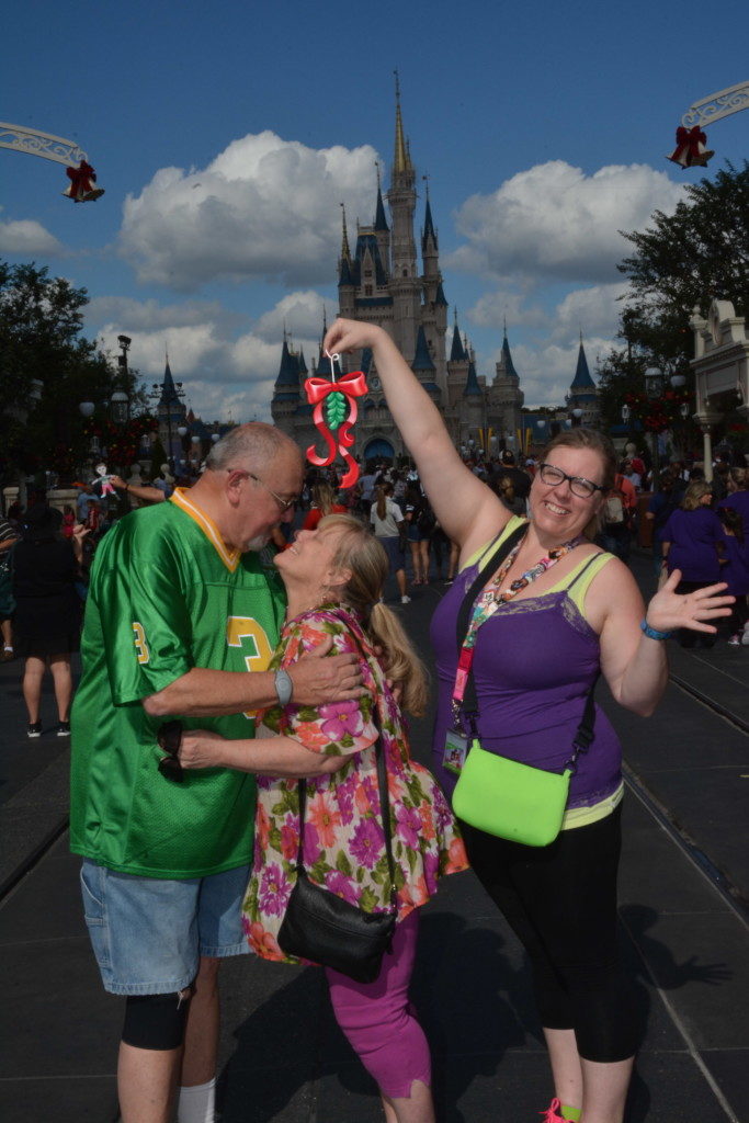 Parents kissing under mistletoe magic shots Disney World