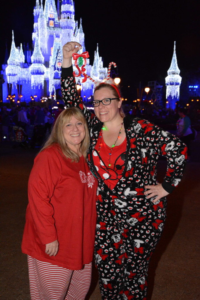 Mom and daughter hugging under mistletoe magic shots Disney World