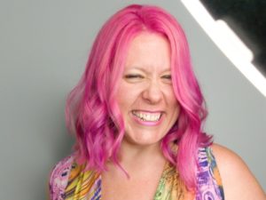 Smiling face with hot pink hair