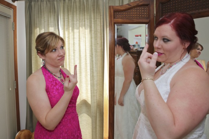 hilarious professional wedding photos  best friends flipping each other off