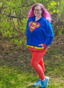 Chrissy posing in a Superman hoodie