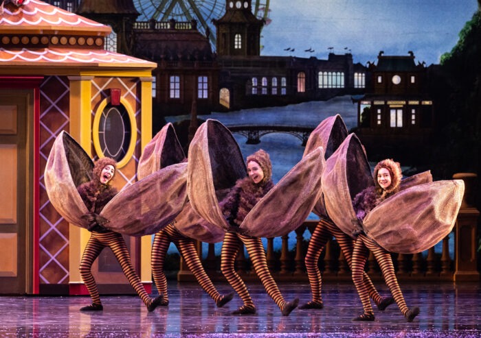 dancers dressed in snapping walnut costumes