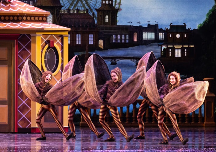 dancers dressed in snapping walnut costumes 